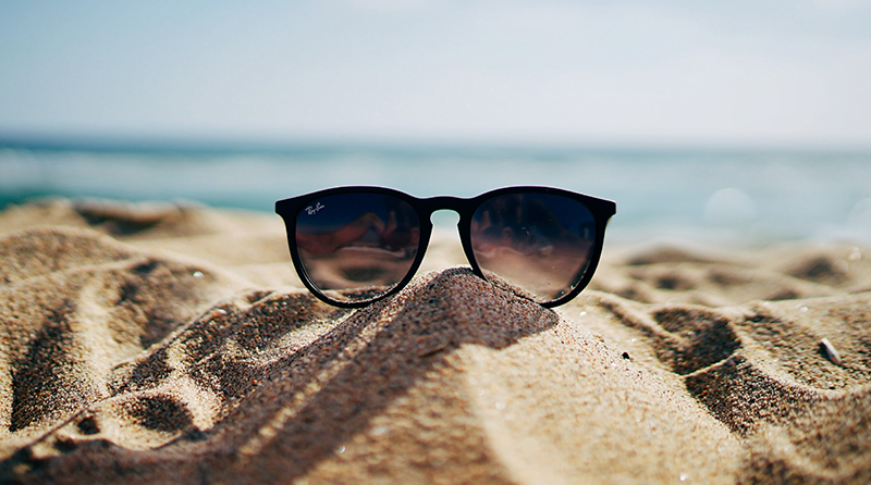 A pair of sunglasses sitting on the beach representing detection efficacy