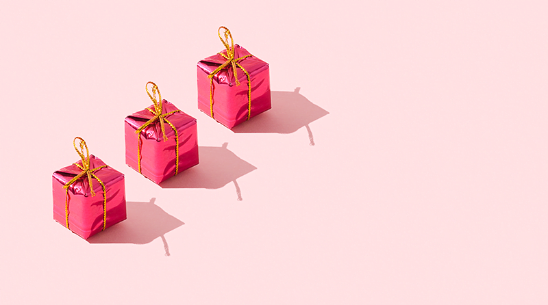 Pink wrapped boxes on a pink background representing retail bot attack